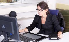 woman at desk on her computer