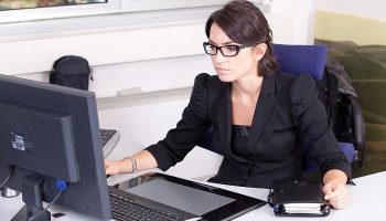 woman at desk on her computer