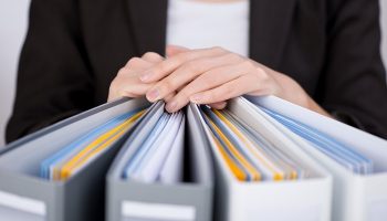businesswoman sifting through documents