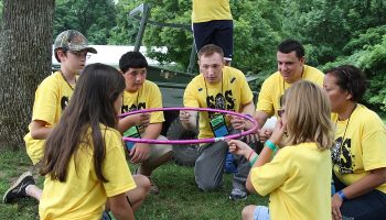 children playing with camp counselors