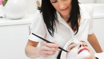 esthetician putting a mask on a customer