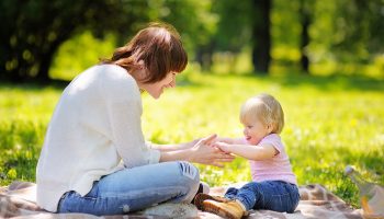 child and her nanny in the park