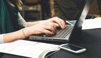 woman typing on a laptop