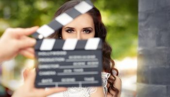actress behind a movie clapboard clapper