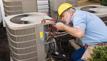 worker fixing HVAC