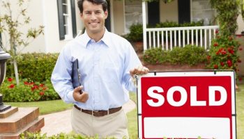 leasing agent next to a sold sign