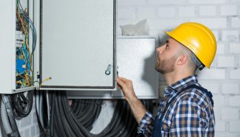 electrician performing maintenance work