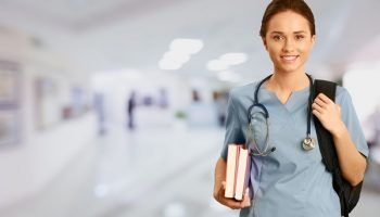 student nurse with books and backpack