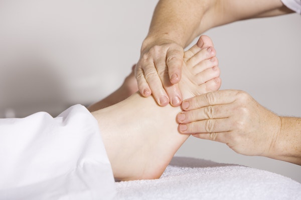 person massaging a foot for therapy
